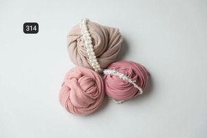 Soft pink fabric wraps arranged delicately on white background.