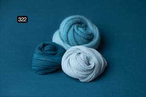Deep teal and light blue fabric wraps styled on dark blue background.