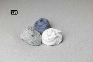 Pale blue and white fabric wraps arranged on neutral gray background.