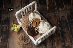 White woven basket with lace and floral elements on a rustic wooden surface.