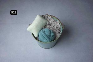 Mint green and pastel blue decorative items arranged on a neutral gray background.