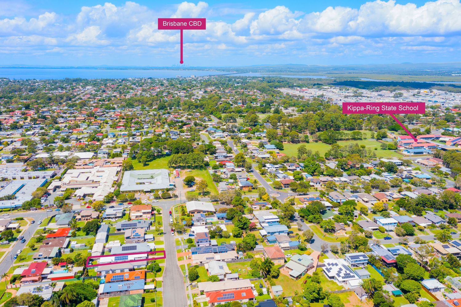 Aerial view showing property location relative to Brisbane CBD and Kippa-Ring State School under clear blue sky.