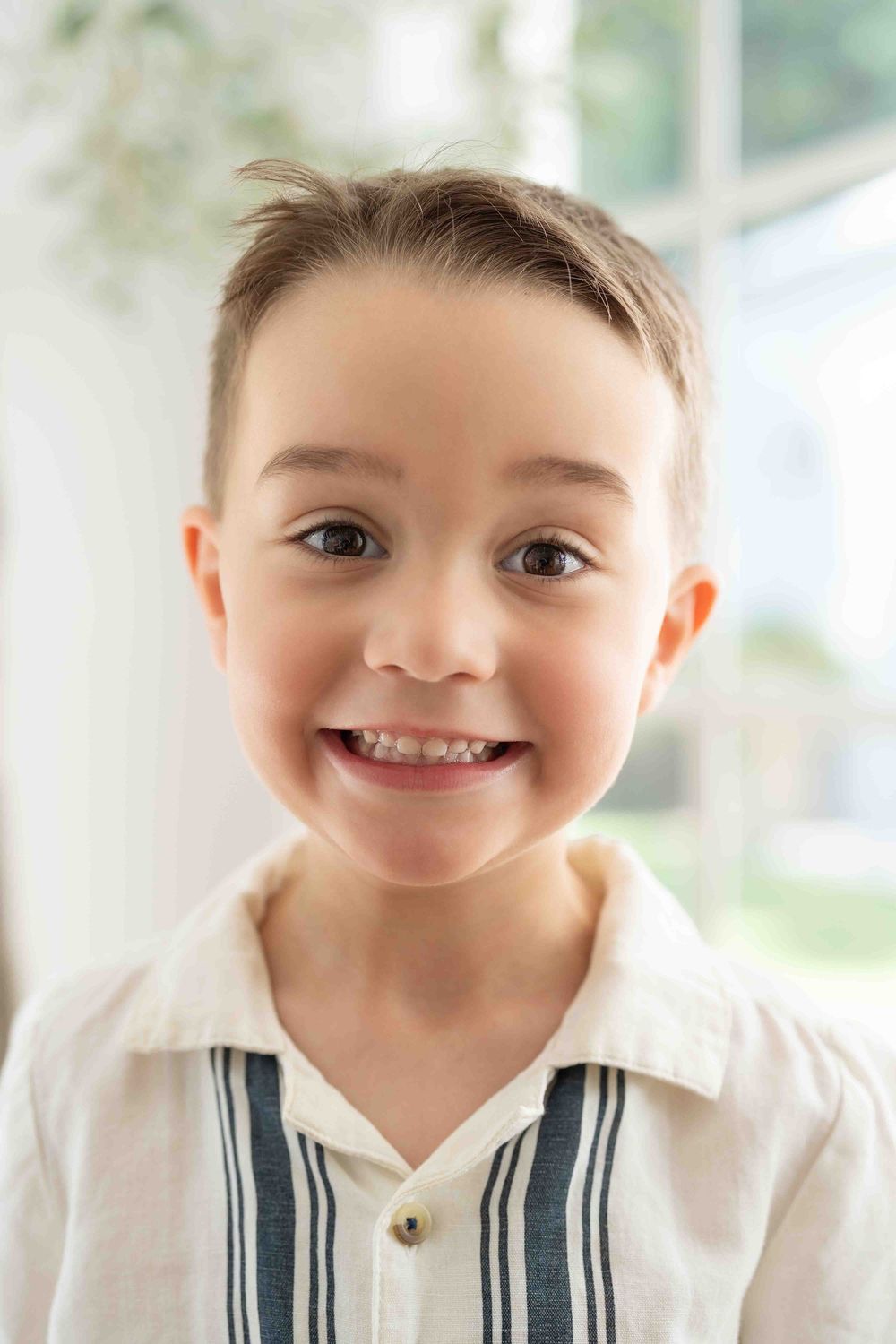 Portrait of a young boy in mid-morning light at an indoor family popup session in Perth