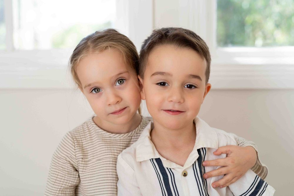 Siblings in mid-morning light during an indoor family photography popup in Perth