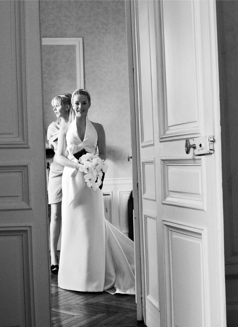 Bride walking through the château doors at Château de Santeny wedding