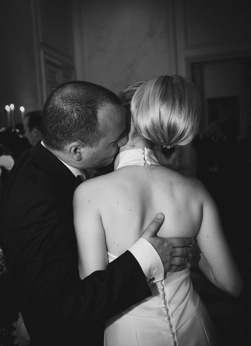 Bride and groom embracing during an evening reception at Château de Santeny