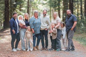 Extended family group portrait taken in wooded forest setting with natural lighting. Squirrel lake, Hanmer Springs