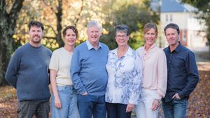 Multi-generational family gathered together for a portrait on a fall afternoon.