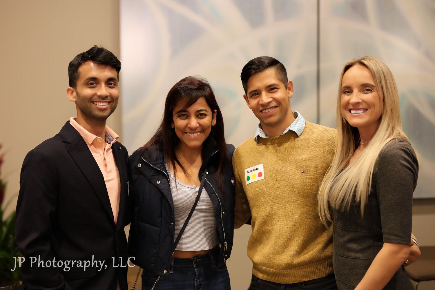 Group photo of business professionals smiling together in a professional office setting.