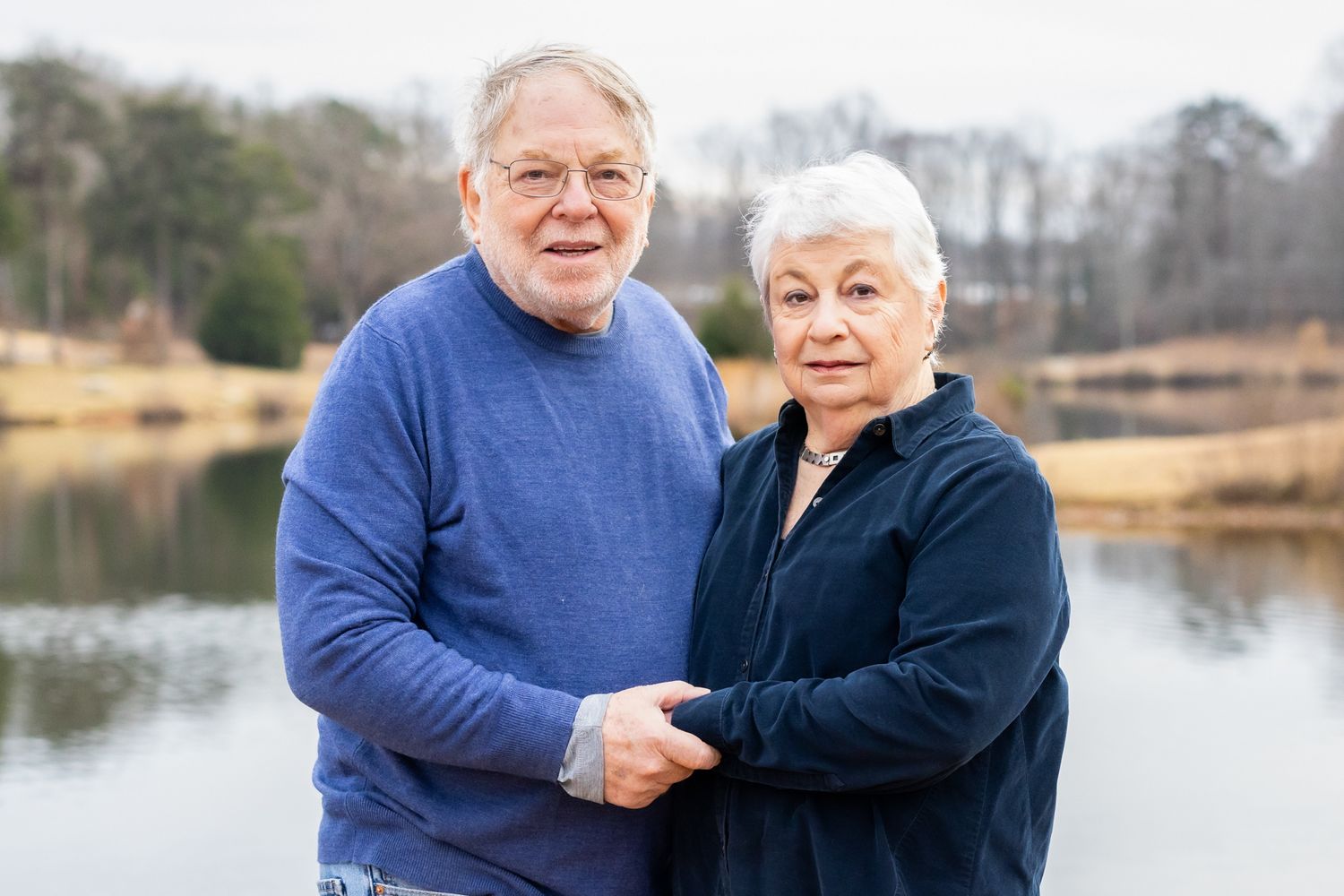 Happy older couple holding hands during a golden hour photo session in Windsor, Ontario.