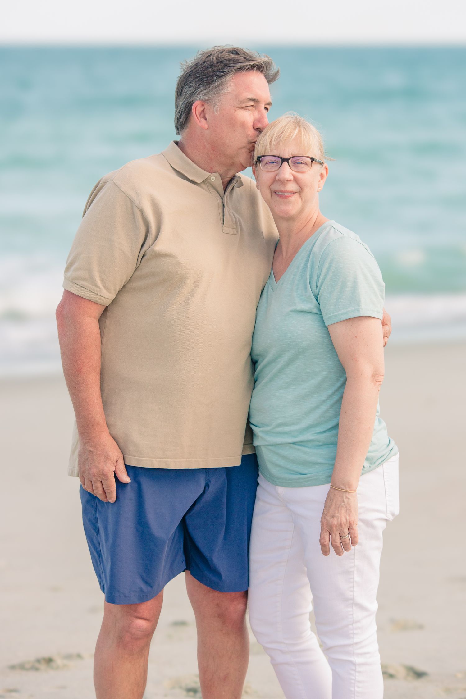 Romantic older couple sharing a quiet moment on the Beach, soft pastel colors in Essex County taken by Tasha Cannaday.