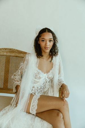 A collection of boudoir photos featuring white lace robes and intimate poses against a light background.