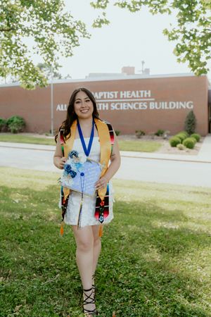 A series of photos showing someone in a blue floral dress posing outdoors near a brick health sciences building.