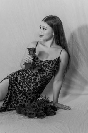 Artistic black and white portrait with roses featuring a leopard print dress.