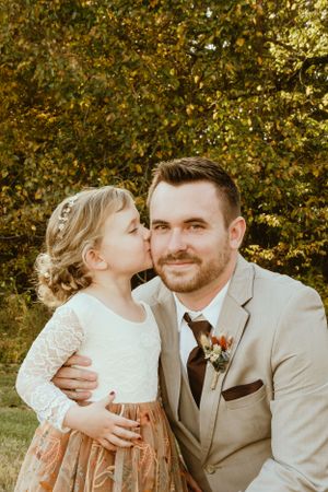 Sweet outdoor wedding portrait in autumn with warm golden lighting.