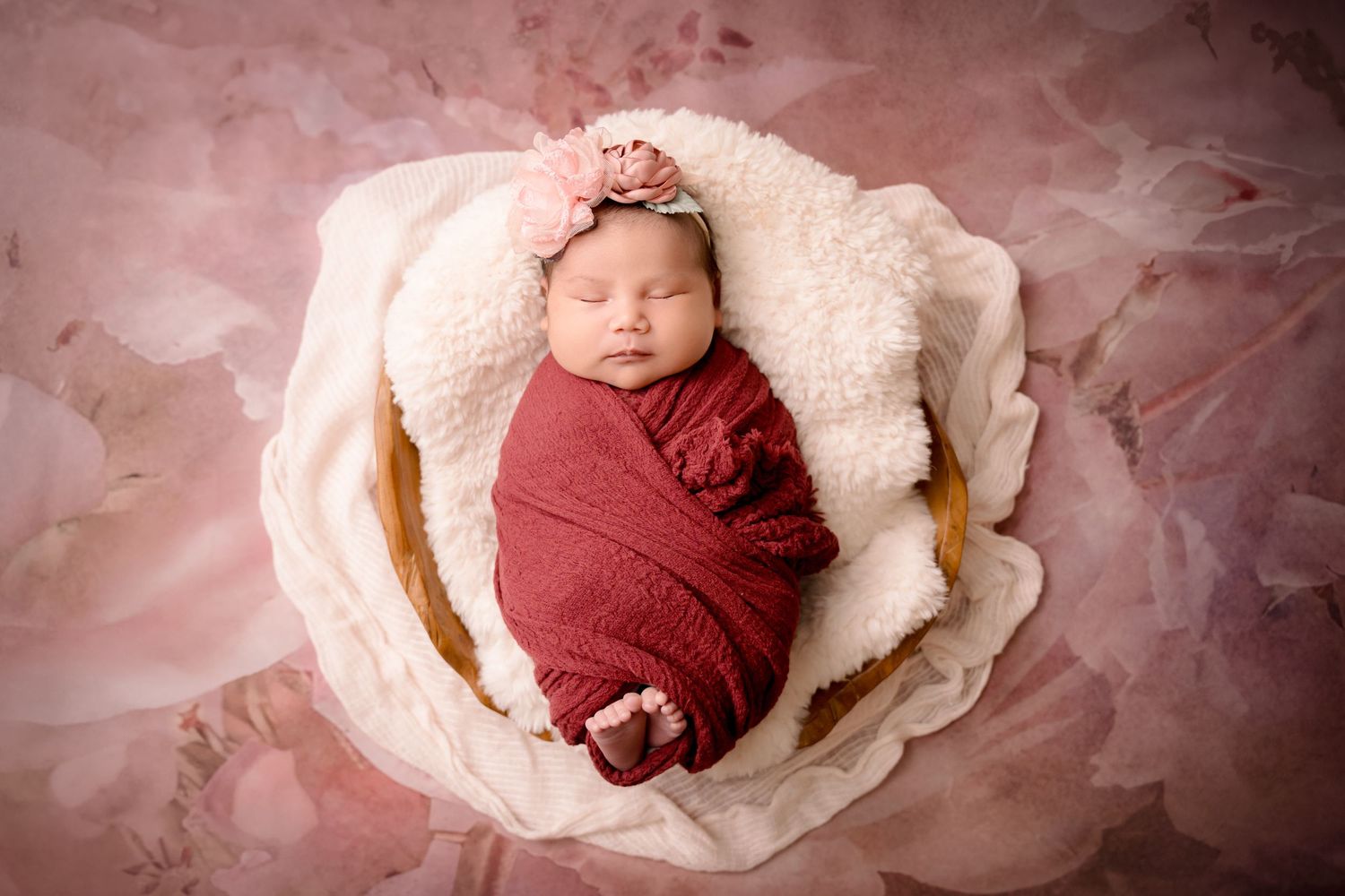Newborn photoshoot Saskatoon and Warman, baby girl in dusty pink and floral props with gold posing flowers prop wrapped