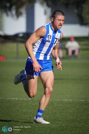 Closeup sequence of an athlete in blue and white striped uniform kicking a ball on a grass sports field.