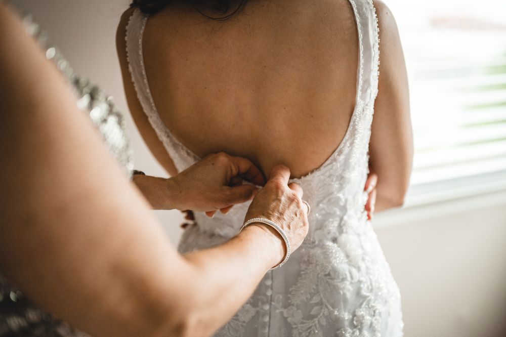 Close-up details of lace and beading on a wedding dress.