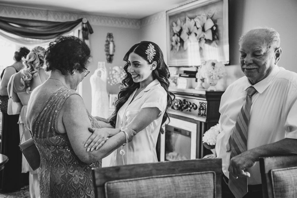 Black and white candid moments from wedding preparation and celebration.