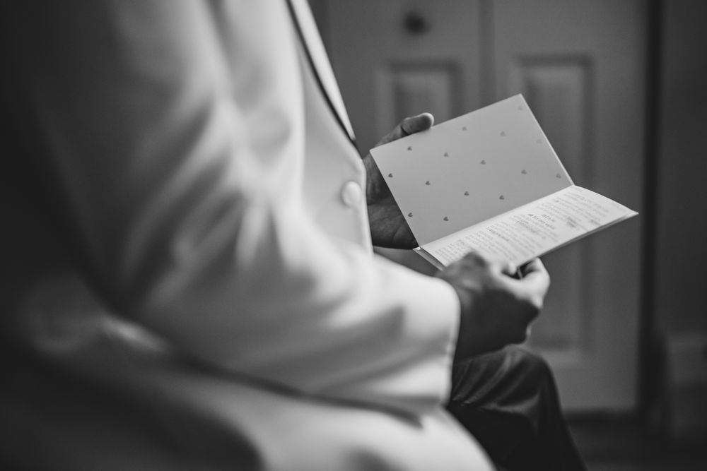 Close up shots of hands holding and adjusting formal documents or papers.