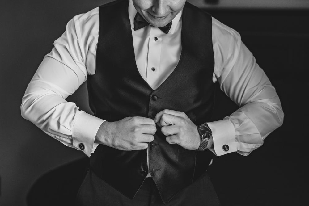 Black and white images showing details of formal wear preparation and adjustments.