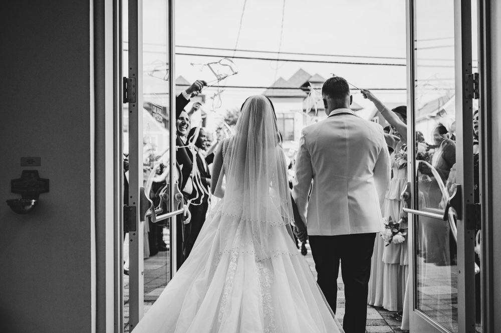 Wedding guests line up outside to celebrate the newlyweds with sparklers during their exit.