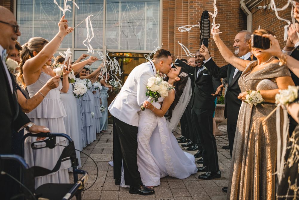Wedding party poses in black and white photo wearing coordinated formal attire.