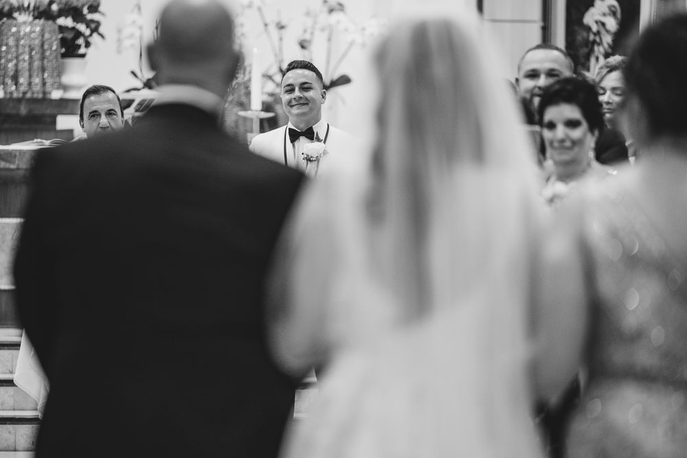 Black and white photo of wedding ceremony moments captured in church setting.
