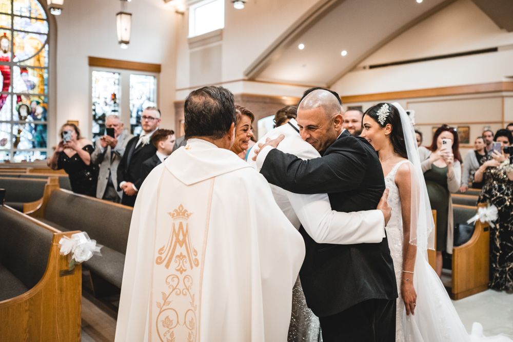 Wedding ceremony moments captured in church with decorative architectural details.