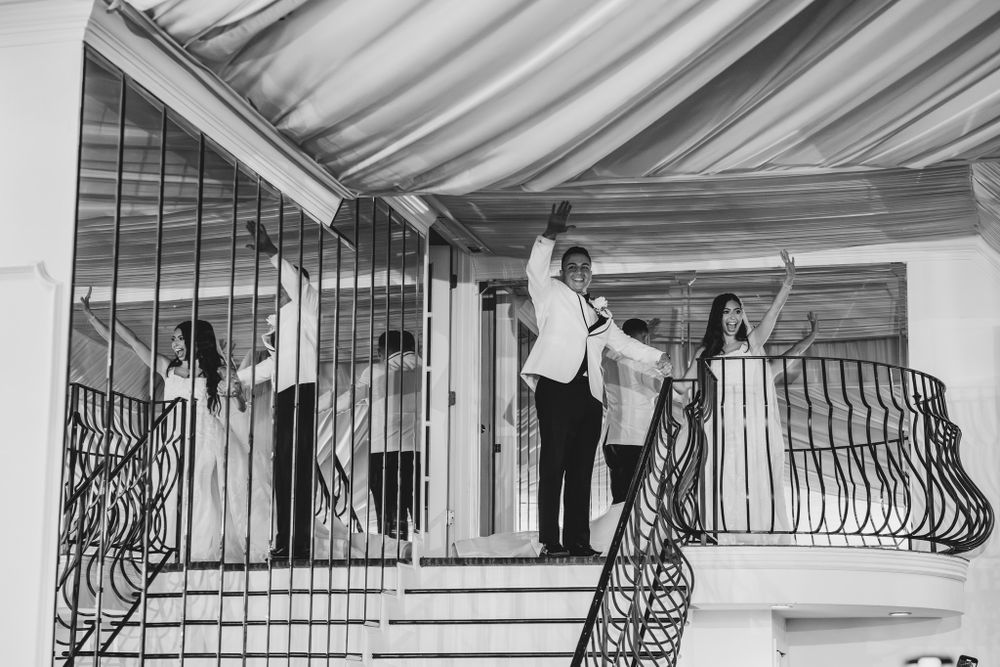 Black and white panoramic view of a wedding venue with decorative railings.