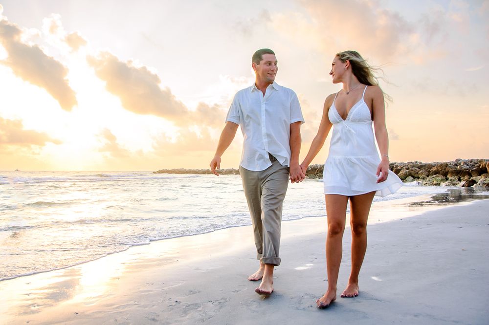 engagement couple walking on the beach in New Port Richey