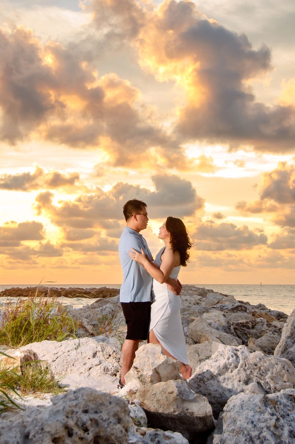 couple embracing in new port richey by rock jetties