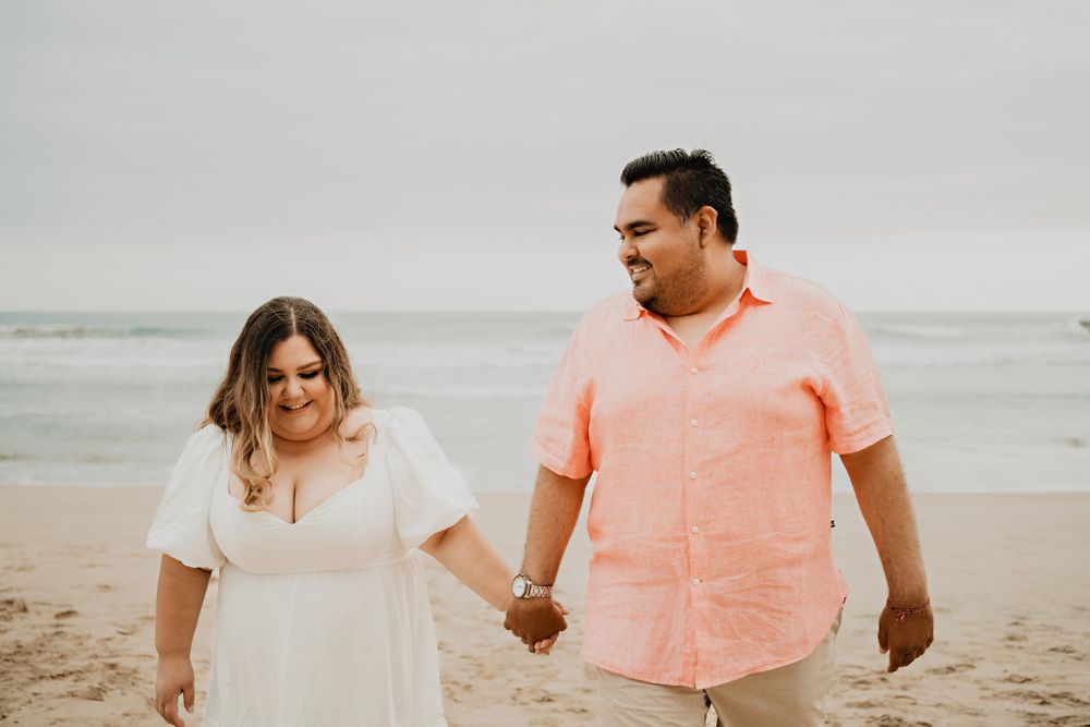 Holding hands, smiling, beach and ocean background