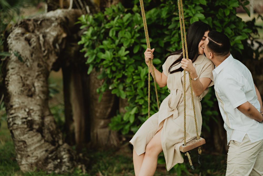 Sharing a kiss on the swing, full of happiness in this pre-wedding adventure