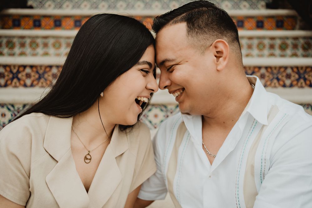 Facing each other, smiling with deep connection, the perfect scene for a wedding photographer to capture