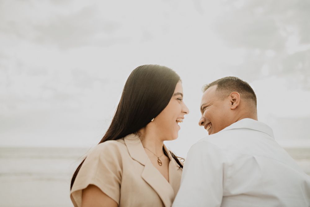 Laughing while looking at each other, capturing the essence of their love in this destination wedding moment