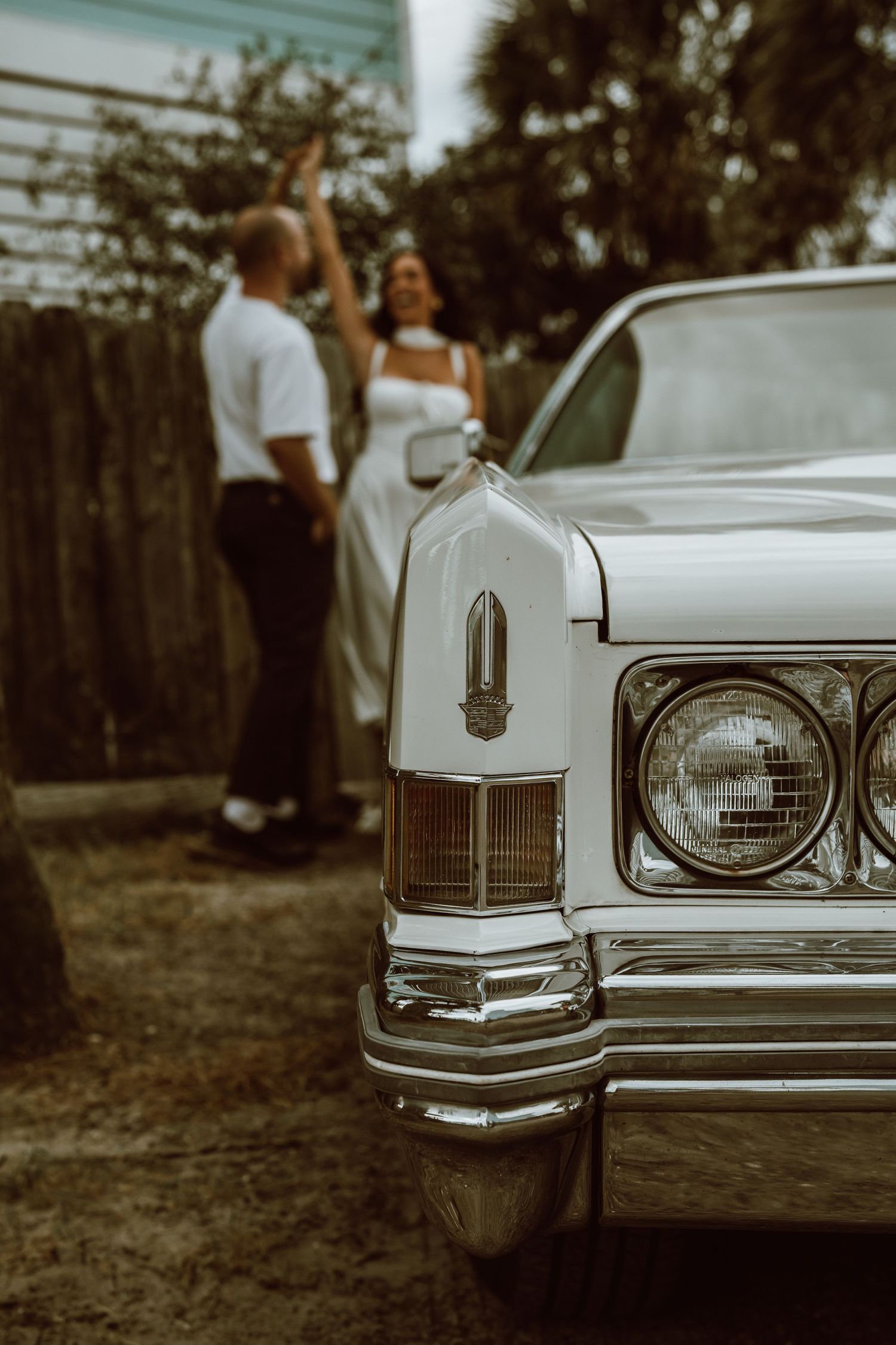Details of a classic white vintage car showing chrome trim and headlights.