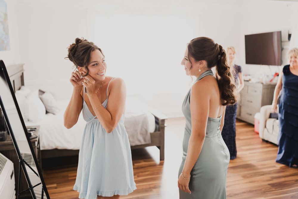 Candid moments between wedding party members in light blue dresses.