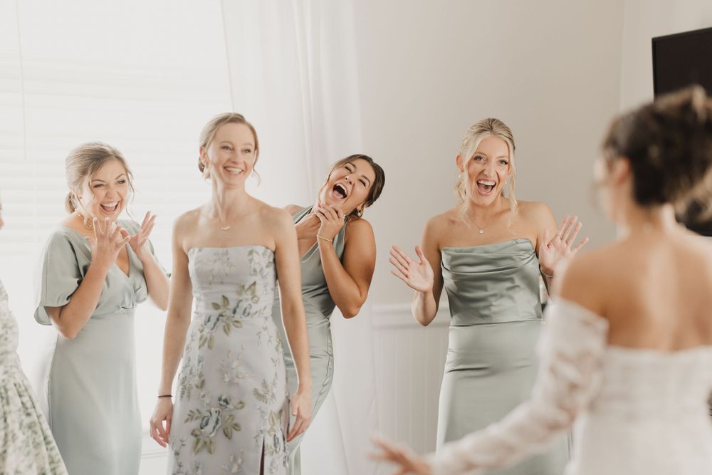 Wedding party reacting with joy and emotion during pre-ceremony preparations.
