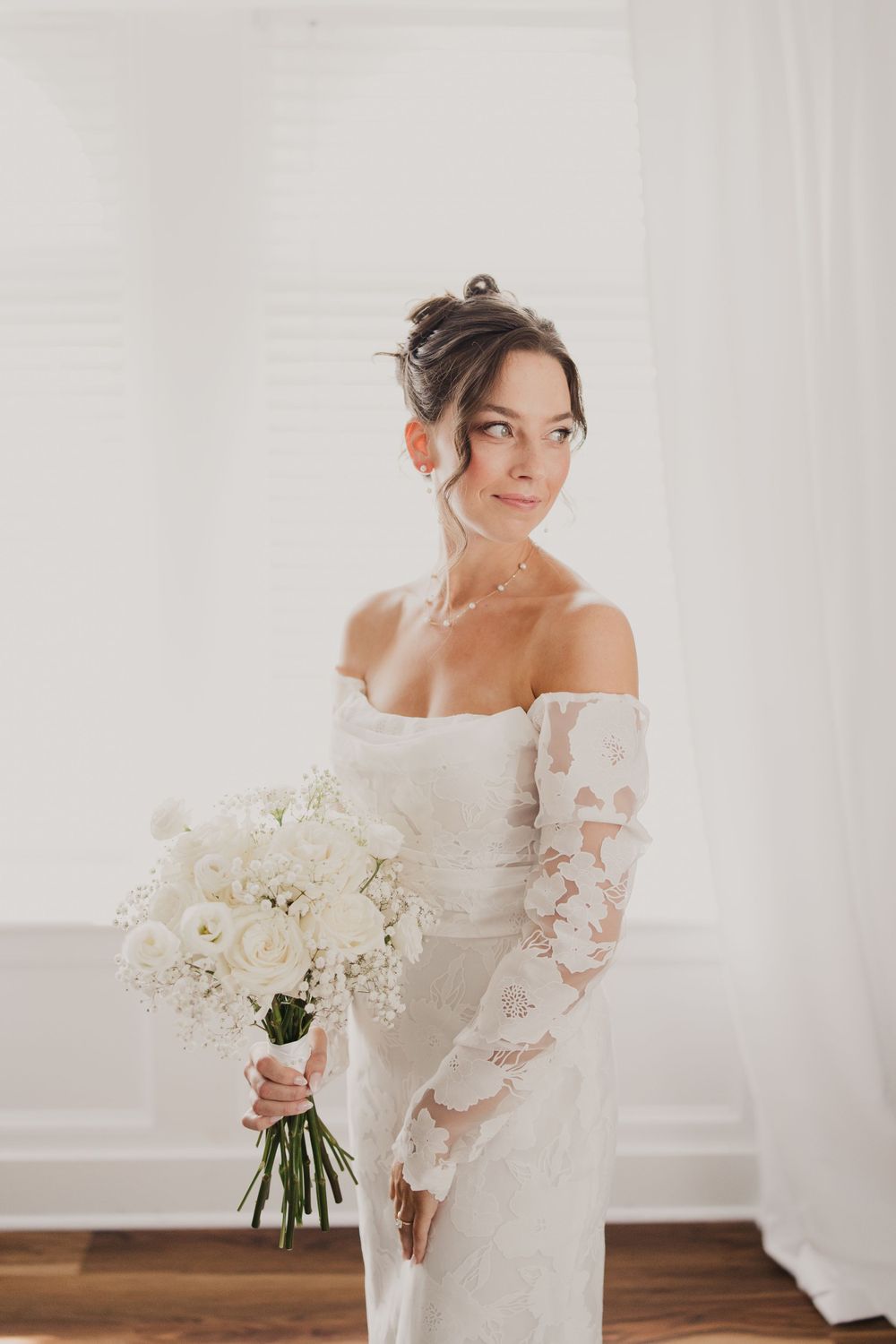 Elegant bridal portraits featuring an off-shoulder lace gown with white floral bouquet.