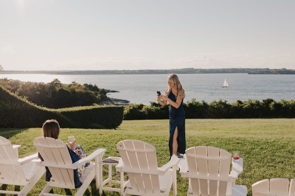 Scenic waterfront wedding venue with Adirondack chairs overlooking the ocean.