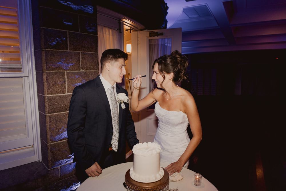 Wedding guests dancing and celebrating on a dark dance floor with purple lighting effects.