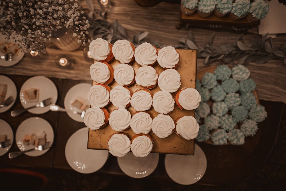 Decorative white paper lanterns and teal accents hanging from wooden beams overhead.