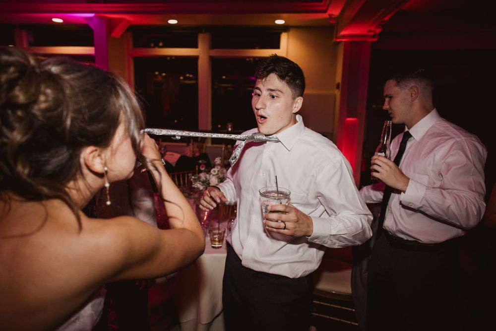 Guests dancing in a dimly lit venue with red ambient lighting.