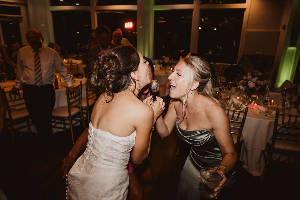 Reception venue at night with large windows and ambient lighting creating an intimate atmosphere.