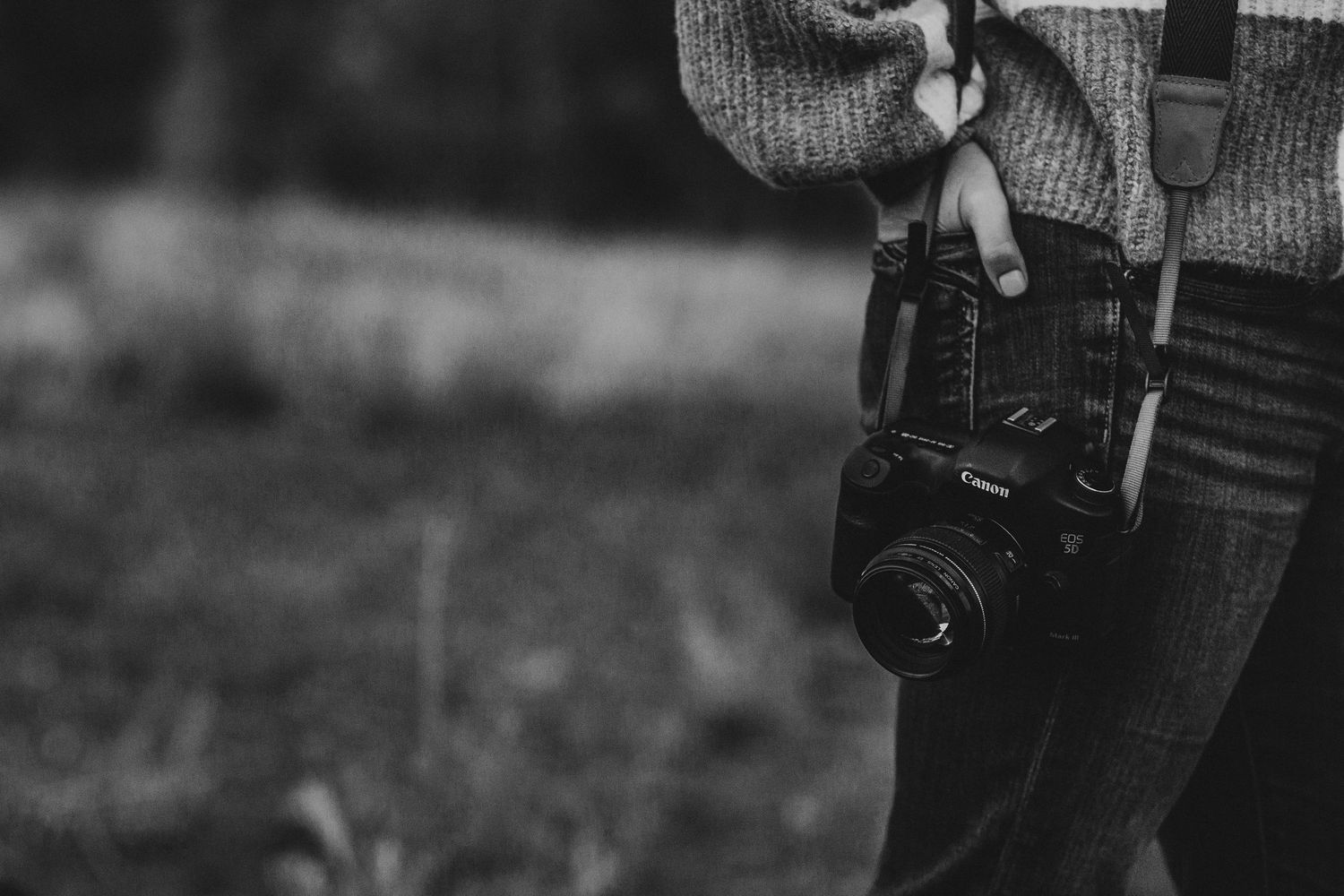 Close-up of camera equipment and gear in black and white.