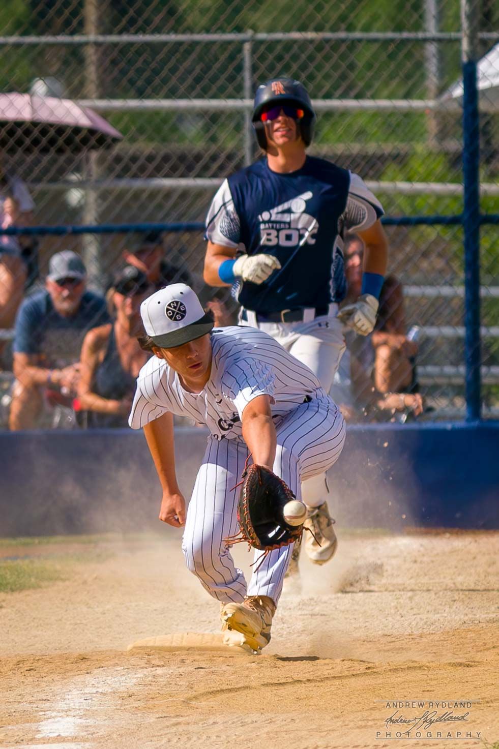 Baseball action at home plate with players creating dust cloud during intense play.