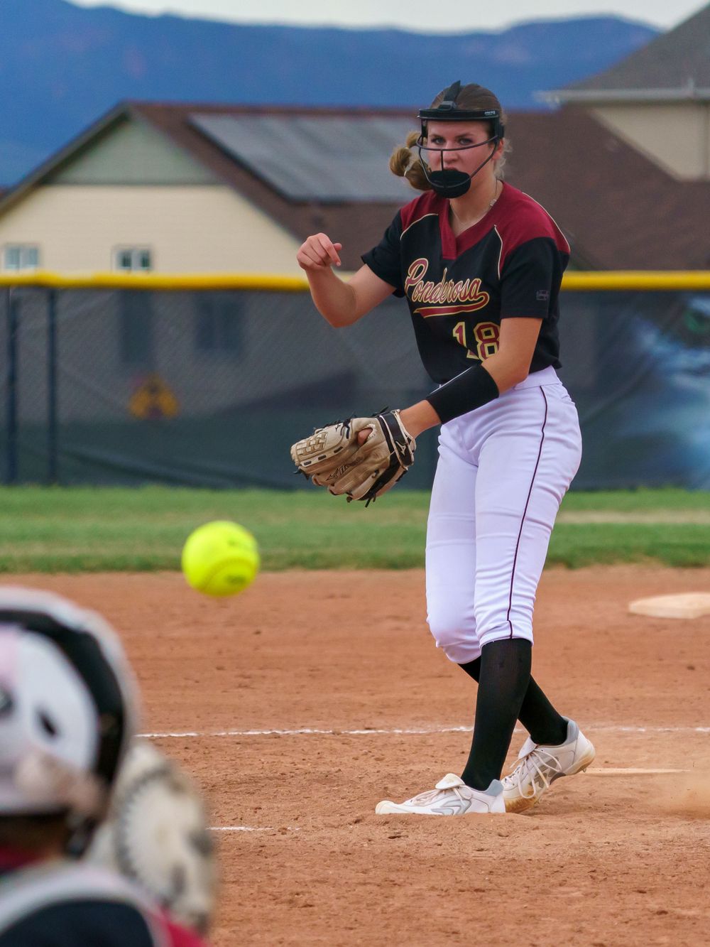 A softball game sequence showing fielding action and a yellow ball in motion.
