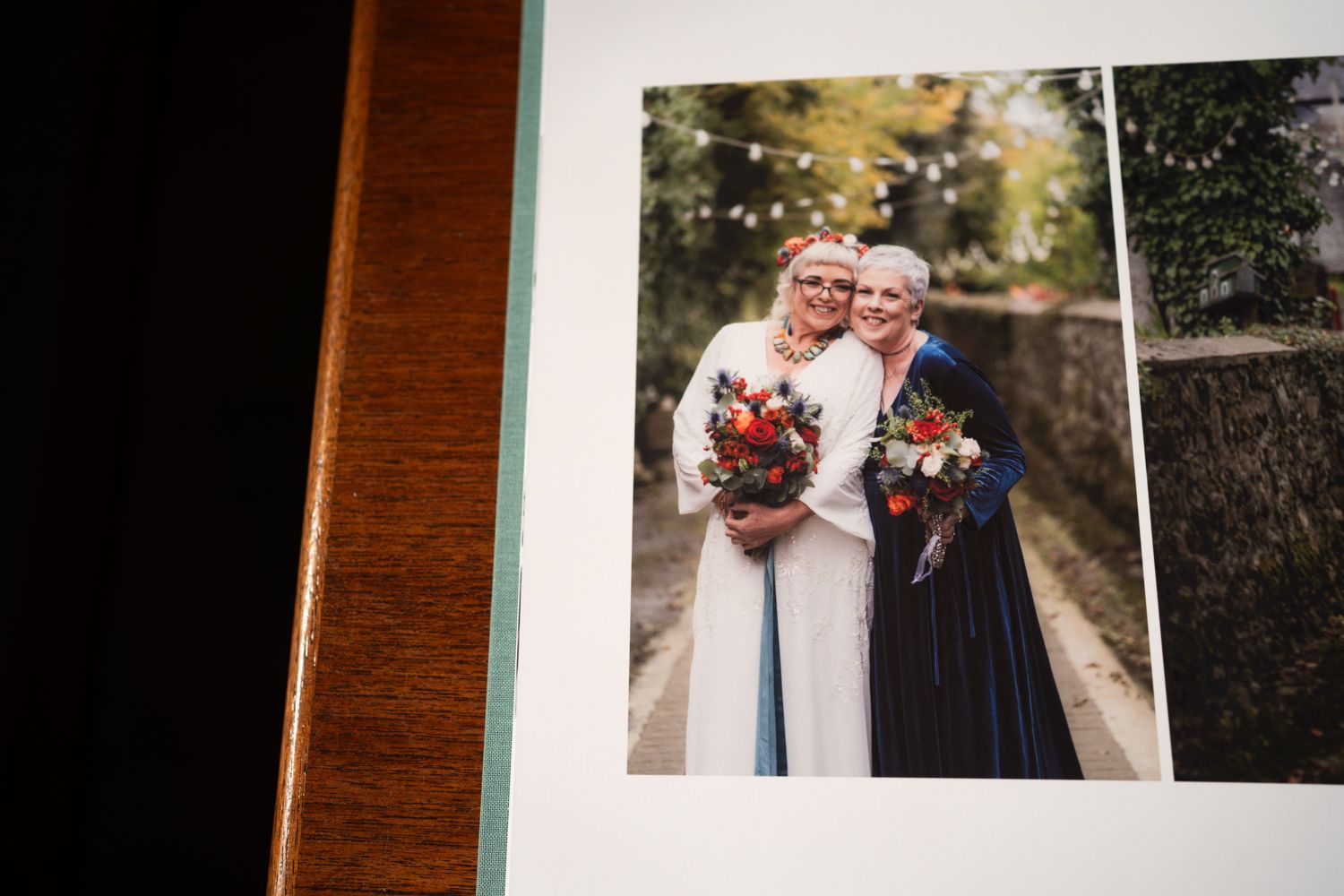 Wedding photo album spread showing an outdoor portrait with floral bouquets and formal attire.