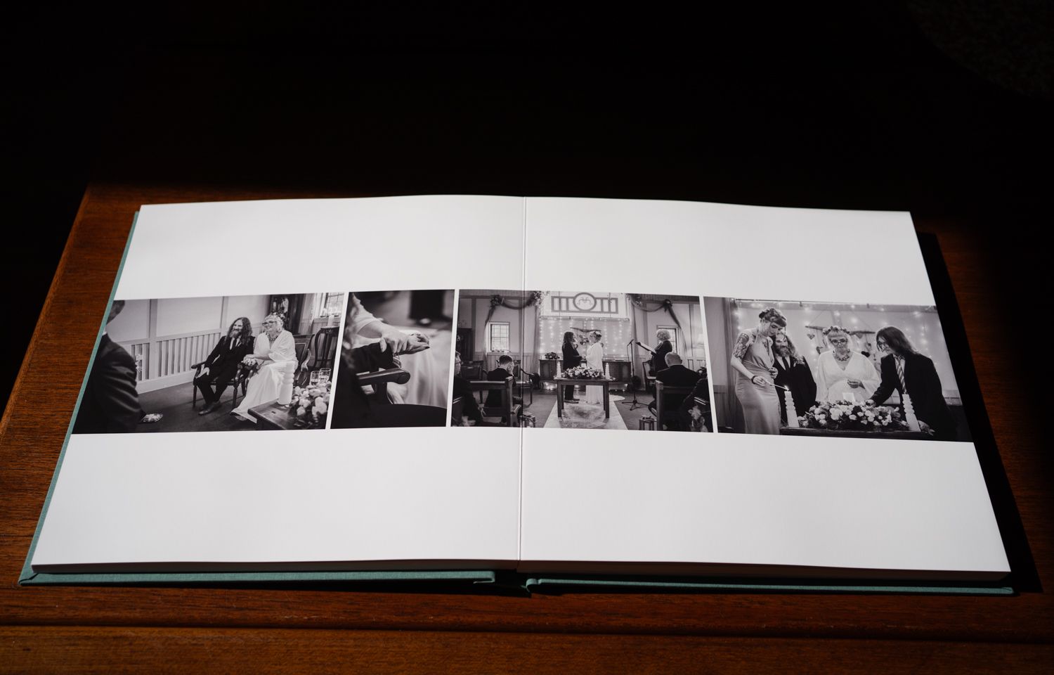 A series of black and white photographs arranged in a row across two pages of an open photo album.